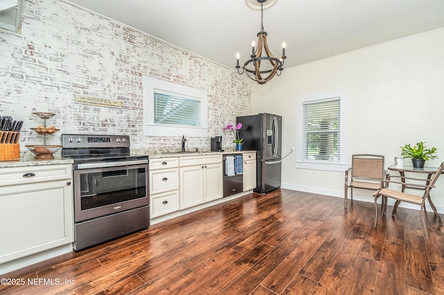148 N 4th St, Macclenny, FL 32063 - kitchen featuring stainless steel appliances, a chandelier, light stone countertops, dark wood-style floors, and white cabinetry