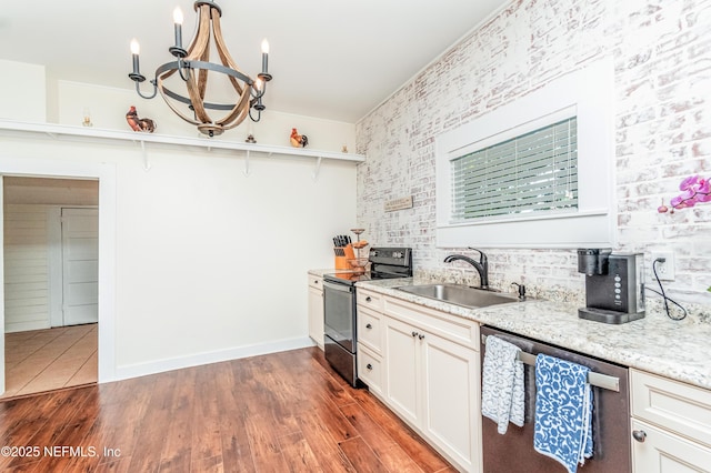 148 N 4th St, Macclenny, FL 32063 - kitchen with appliances with stainless steel finishes, a sink, a chandelier, open shelves, and light stone countertops
