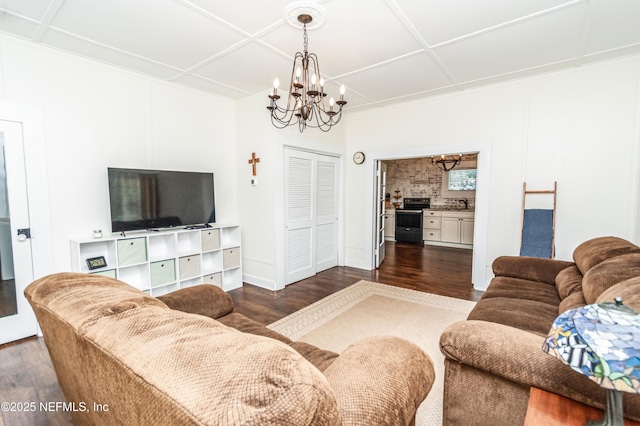 148 N 4th St, Macclenny, FL 32063 - living room featuring a chandelier and dark wood-type flooring