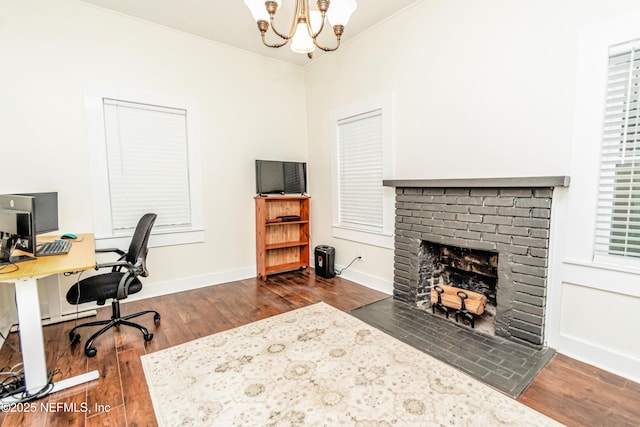148 N 4th St, Macclenny, FL 32063 - office with a chandelier, dark wood-style flooring, a fireplace, and baseboards