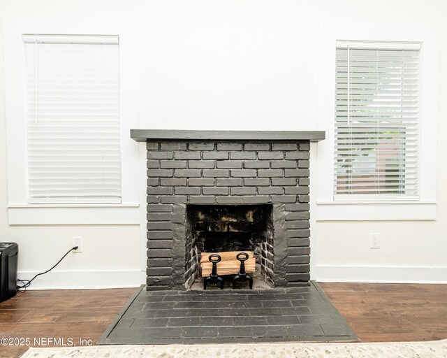 148 N 4th St, Macclenny, FL 32063 - detailed view of wood finished floors, baseboards, and a fireplace