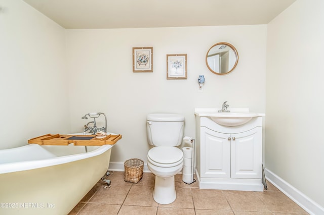 148 N 4th St, Macclenny, FL 32063 - bathroom featuring tile patterned floors, toilet, a freestanding bath, vanity, and baseboards