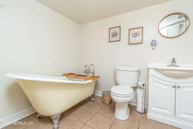 148 N 4th St, Macclenny, FL 32063 - full bath featuring tile patterned flooring, toilet, a freestanding tub, vanity, and baseboards