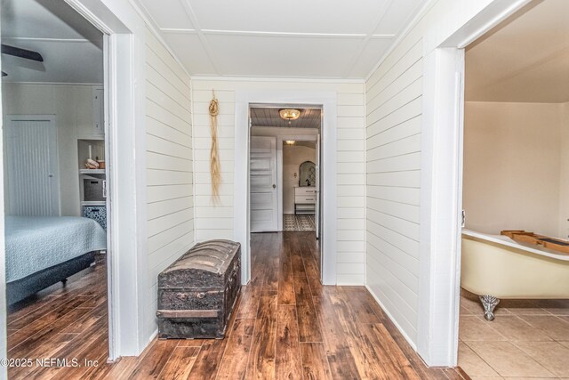 148 N 4th St, Macclenny, FL 32063 - hall featuring wood walls, wood finished floors, and baseboards