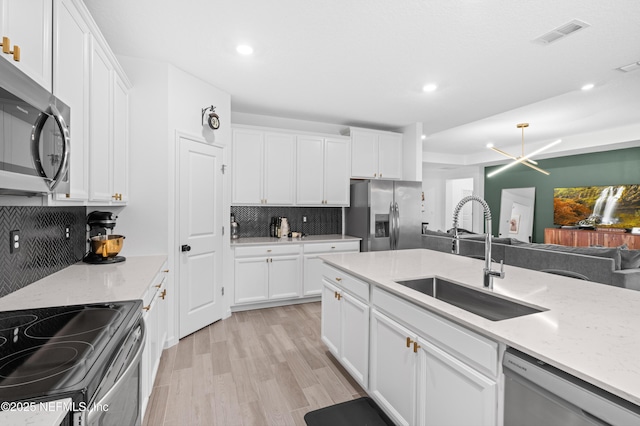 7242 Calamint Ave, Jacksonville, FL 32219 - kitchen with stainless steel appliances, a sink, decorative backsplash, light wood-type flooring, and recessed lighting