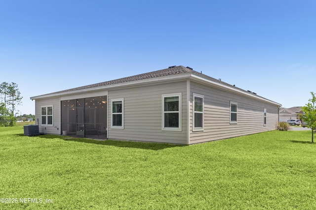7242 Calamint Ave, Jacksonville, FL 32219 - back of property with cooling unit, a lawn, and a sunroom