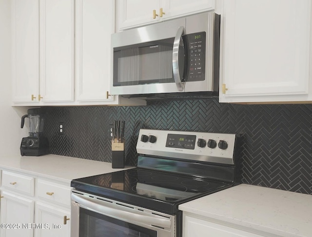 7242 Calamint Ave, Jacksonville, FL 32219 - kitchen featuring stainless steel appliances, white cabinets, and backsplash