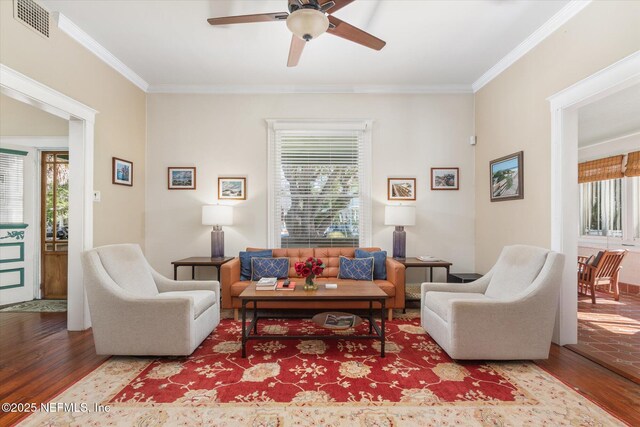24 Sevilla St, Saint Augustine, FL 32084 - living area with wood finished floors, a ceiling fan, and crown molding