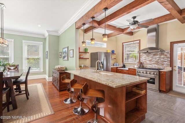 24 Sevilla St, Saint Augustine, FL 32084 - kitchen featuring stainless steel appliances, wall chimney range hood, open shelves, a sink, and beam ceiling