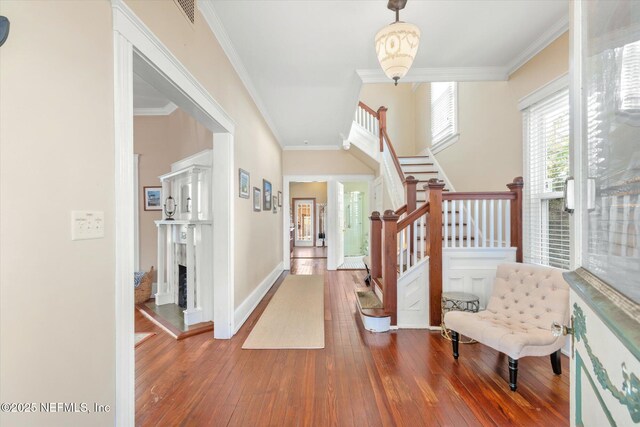 24 Sevilla St, Saint Augustine, FL 32084 - entryway featuring hardwood / wood-style floors, stairs, ornamental molding, baseboards, and a premium fireplace