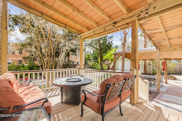 24 Sevilla St, Saint Augustine, FL 32084 - wooden deck featuring a fire pit, outdoor dining area, and a fenced backyard