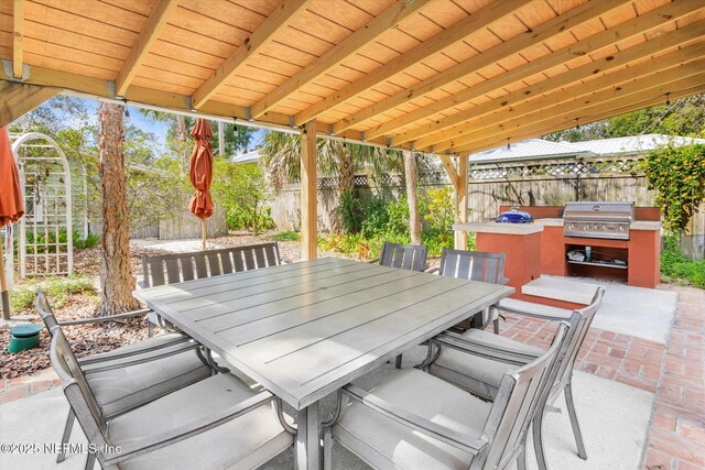 24 Sevilla St, Saint Augustine, FL 32084 - fenced backyard featuring outdoor dining space, a grill, and a patio