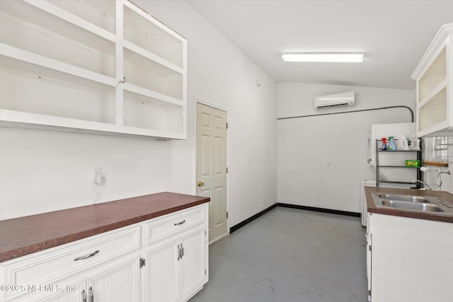 24 Sevilla St, Saint Augustine, FL 32084 - kitchen with open shelves, a wall mounted air conditioner, a sink, concrete flooring, and lofted ceiling