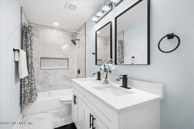 619 S 10th St, Fernandina Beach, FL 32034 - full bathroom with marble finish flooring, double vanity, shower / bathtub combination with curtain, toilet, and baseboards