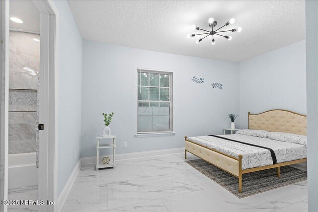 619 S 10th St, Fernandina Beach, FL 32034 - bedroom with light marble finish flooring, a chandelier, baseboards, and a textured ceiling