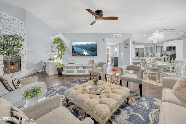 1113 Lee Rd, Jacksonville, FL 32225 - living room featuring dark wood finished floors, a chandelier, ceiling fan, and a stone fireplace