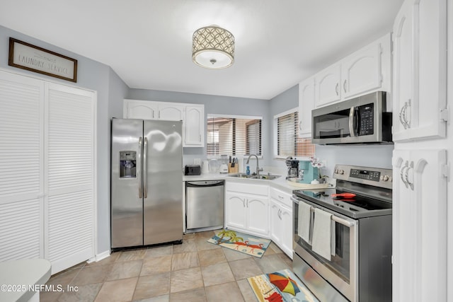 1113 Lee Rd, Jacksonville, FL 32225 - kitchen with appliances with stainless steel finishes, a sink, white cabinets, and light countertops