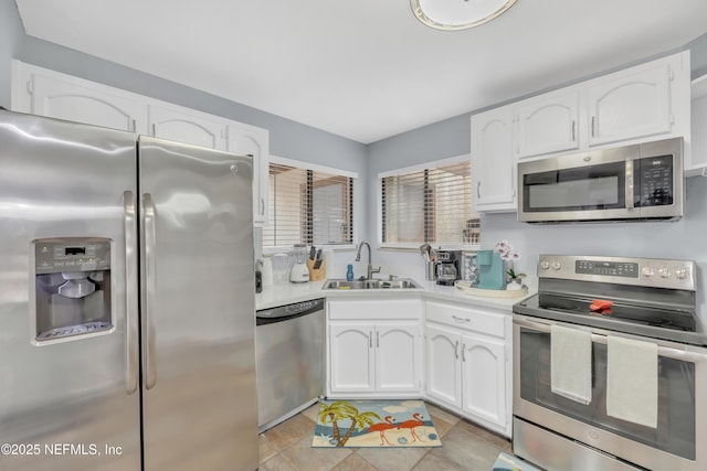 1113 Lee Rd, Jacksonville, FL 32225 - kitchen with appliances with stainless steel finishes, a sink, white cabinets, and light countertops