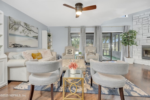 1113 Lee Rd, Jacksonville, FL 32225 - living room with a ceiling fan, a stone fireplace, and wood finished floors