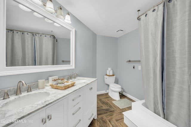 1113 Lee Rd, Jacksonville, FL 32225 - bathroom featuring baseboards, toilet, and double vanity