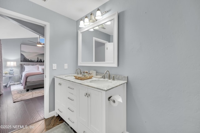 1113 Lee Rd, Jacksonville, FL 32225 - ensuite bathroom with double vanity, wood finished floors, and baseboards