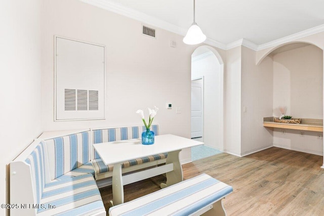 12700 Bartram Park Blvd Unit 1911, Jacksonville, FL 32258 - dining area with light wood finished floors, ornamental molding, breakfast area, and arched walkways