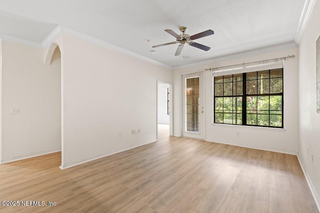 12700 Bartram Park Blvd Unit 1911, Jacksonville, FL 32258 - spare room featuring light wood finished floors, crown molding, arched walkways, a ceiling fan, and baseboards