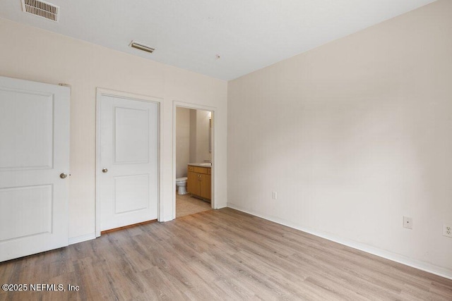 12700 Bartram Park Blvd Unit 1911, Jacksonville, FL 32258 - unfurnished bedroom featuring light wood-style floors, baseboards, and ensuite bathroom