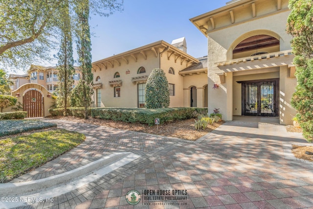 12700 Bartram Park Blvd Unit 1911, Jacksonville, FL 32258 - view of front of home featuring stucco siding, a gate, and a chimney