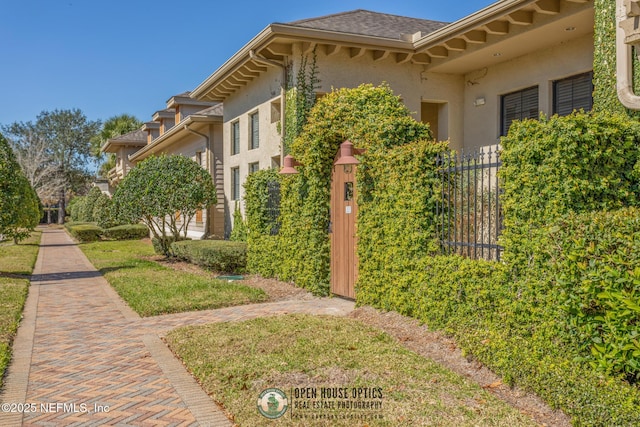 12700 Bartram Park Blvd Unit 1911, Jacksonville, FL 32258 - view of side of home with stucco siding and a shingled roof
