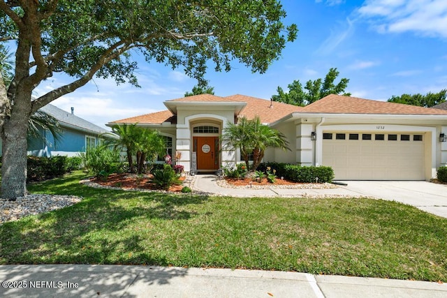 1252 Paradise Pond Rd, Saint Augustine, FL 32092 - view of front of home with a garage, concrete driveway, a front lawn, and stucco siding