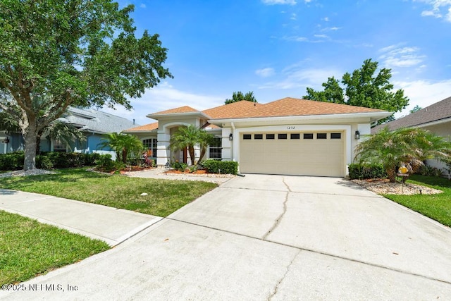 1252 Paradise Pond Rd, Saint Augustine, FL 32092 - view of front facade featuring an attached garage, driveway, a front yard, and stucco siding
