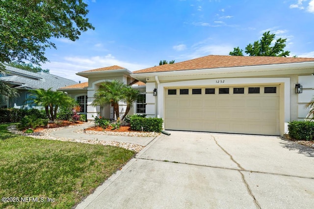 1252 Paradise Pond Rd, Saint Augustine, FL 32092 - view of front of house with stucco siding, a garage, driveway, and a front yard
