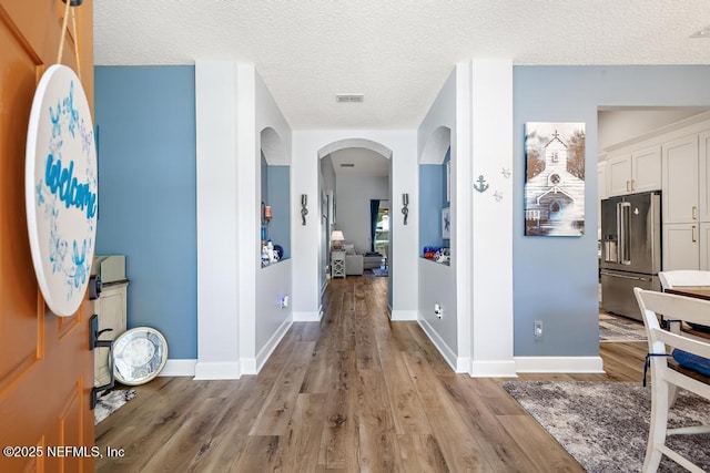 1252 Paradise Pond Rd, Saint Augustine, FL 32092 - entryway featuring arched walkways, wood finished floors, baseboards, and a textured ceiling