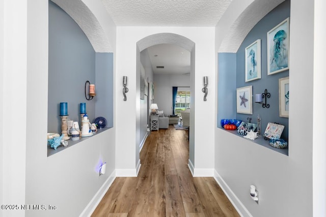 1252 Paradise Pond Rd, Saint Augustine, FL 32092 - hallway with wood finished floors, a textured ceiling, and baseboards