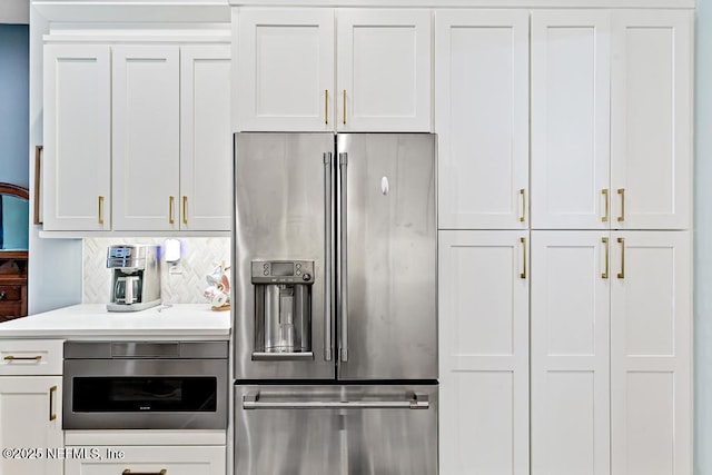 1252 Paradise Pond Rd, Saint Augustine, FL 32092 - kitchen with high end fridge, backsplash, white cabinets, and light countertops