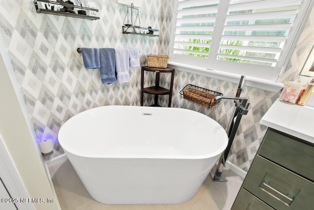 1252 Paradise Pond Rd, Saint Augustine, FL 32092 - bathroom with wallpapered walls, a freestanding bath, baseboards, and tile patterned floors