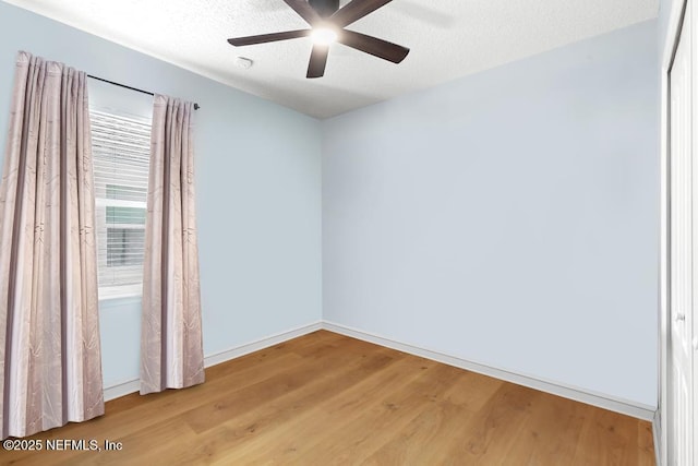1252 Paradise Pond Rd, Saint Augustine, FL 32092 - unfurnished room featuring wood finished floors, baseboards, a ceiling fan, and a textured ceiling