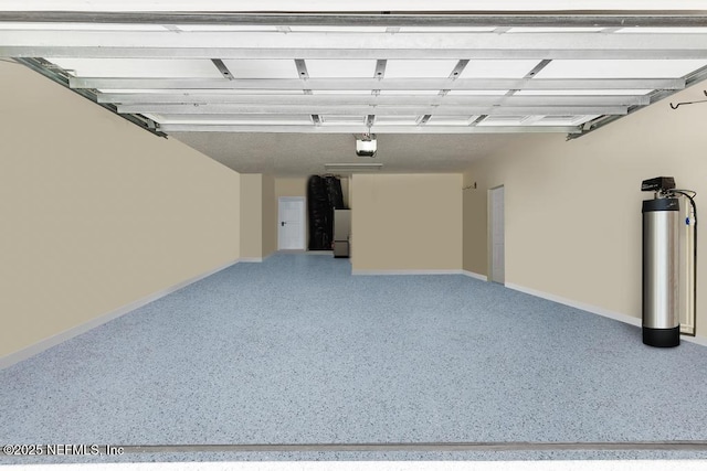 1252 Paradise Pond Rd, Saint Augustine, FL 32092 - garage featuring a garage door opener, baseboards, and freestanding refrigerator