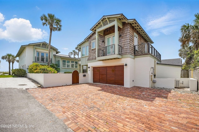 816 Ocean Front, Neptune Beach, FL 32266 - view of front of property featuring a balcony, an attached garage, and decorative driveway