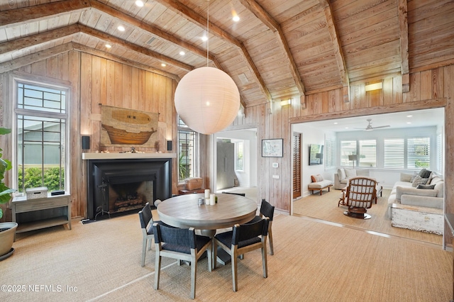 816 Ocean Front, Neptune Beach, FL 32266 - dining space with wood ceiling, a fireplace with flush hearth, wood walls, carpet floors, and a ceiling fan