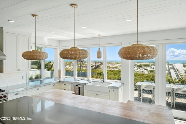 816 Ocean Front, Neptune Beach, FL 32266 - kitchen with a sink, healthy amount of natural light, white cabinetry, pendant lighting, and recessed lighting