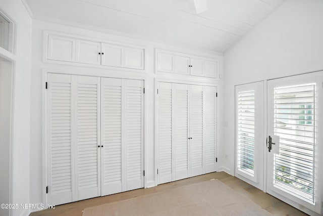 816 Ocean Front, Neptune Beach, FL 32266 - unfurnished bedroom featuring multiple closets, wood finished floors, and vaulted ceiling