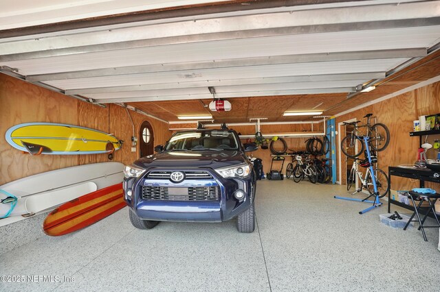 816 Ocean Front, Neptune Beach, FL 32266 - garage with a garage door opener and wooden walls