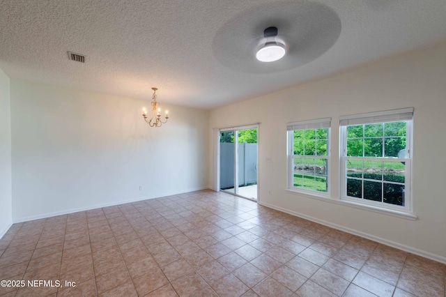 1843 Biscayne Bay Cir, Jacksonville, FL 32218 - spare room featuring a chandelier, a textured ceiling, light tile patterned flooring, and baseboards