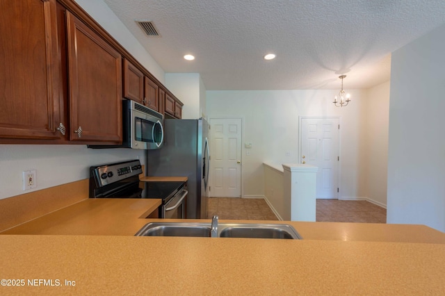 1843 Biscayne Bay Cir, Jacksonville, FL 32218 - kitchen featuring stainless steel appliances, a sink, light countertops, a chandelier, and recessed lighting