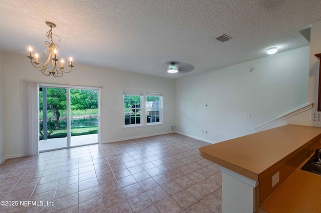 1843 Biscayne Bay Cir, Jacksonville, FL 32218 - unfurnished room with a chandelier, light tile patterned floors, a textured ceiling, and baseboards