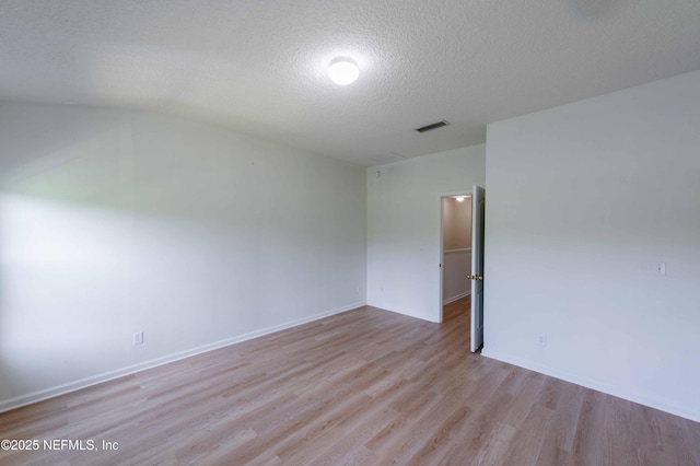 1843 Biscayne Bay Cir, Jacksonville, FL 32218 - unfurnished room with wood finished floors, a textured ceiling, vaulted ceiling, and baseboards