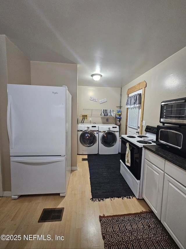 104 Palm Dr, Georgetown, FL 32139 - washroom featuring washing machine and clothes dryer and light wood-style flooring
