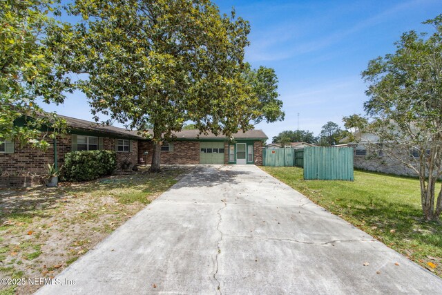 1073 Grove Park Ln, Orange Park, FL 32073 - ranch-style house featuring an attached garage, brick siding, and driveway